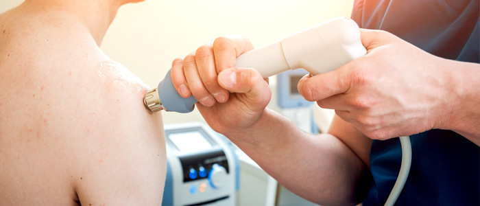 a photo of a person receiving shockwave therapy treatment